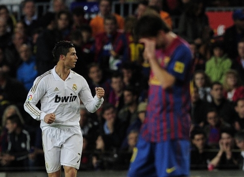 Real Madrid's Portuguese forward Cristiano Ronaldo (L) celebrates after scoring during the Spanish League 'El clasico' football match Barcelona vs Real Madrid at the Camp Nou stadium in Barcelona on April 21, 2012.