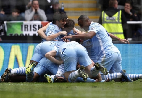 Manchester City players celebrate on top of Yaya Toure after he scored his first goal against Newcastle United during their English Premier League soccer match in Newcastle, north east England May 6, 2012.