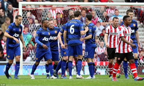 Delight: United celebrate Wayne Rooney's crucial goal at Sunderland - before City's big collapse