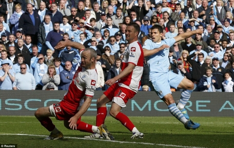 Ice cool: Aguero blasts home to seal the 3-2 victory that made City champions after a 44-year wait