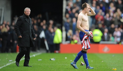 Shocked: Sir Alex Ferguson looks visibly stunned by the late news coming in from City