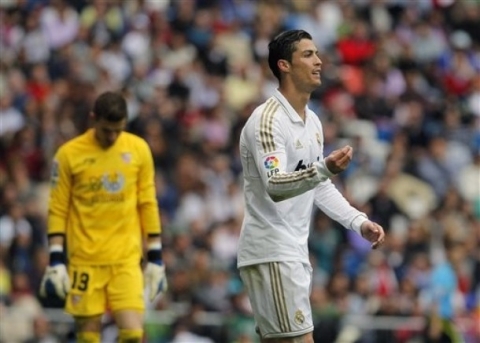 Real Madrid's Cristiano Ronaldo from Portugal, right, gestures during a Spanish La Liga soccer match against Sevilla at the Santiago Bernabeu stadium in Madrid, Spain, Sunday, April 29, 2012.