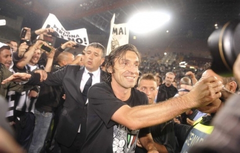Juventus' Andrea Pirlo celebrates with fans after winning the Italian Serie A title at the end of the match against Cagliari at the Nereo Rocco stadium in Trieste May 6, 2012. Juventus won Serie A for the first time since the Calciopoli match-fixing scandal on Sunday, clinching the title with a 2-0 win at Calgiari as AC Milan lost 4-2 to arch-rivals Inter in a stormy derby.