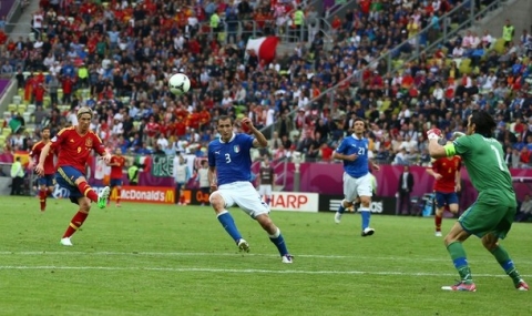 GDANSK, POLAND - JUNE 10:  Fernando Torres of Spain chips the ball over Gianluigi Buffon of Italy during the UEFA EURO 2012 group C match between Spain and Italy at The Municipal Stadium on June 10, 2012 in Gdansk, Poland.