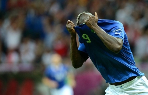 Italian forward Mario Balotelli takes his jersey off after scoring during the Euro 2012 football championships semi-final match Germany vs Italy on June 28, 2012 at the National Stadium in Warsaw.