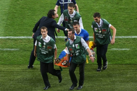 KIEV, UKRAINE - JULY 01: Thiago Motta of Italy is stretched off the pitch during the UEFA EURO 2012 final match between Spain and Italy at the Olympic Stadium on July 1, 2012 in Kiev, Ukraine.