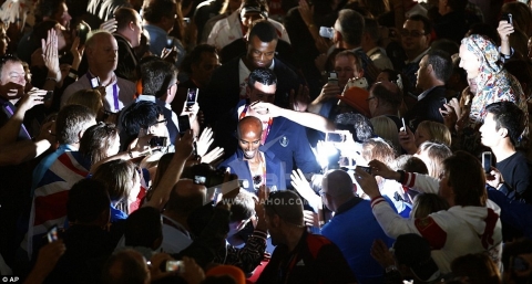 Mobbed: Mo Farah and the Team GB athletes were applauded as they made their way round the arena