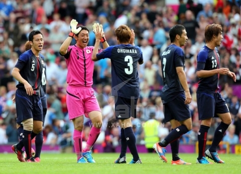 MANCHESTER, ENGLAND - AUGUST 04: Japan players celebrates after they defeated Egypt 3-0 during the Men's Football Quarter Final match between  Japan and Egypt, on Day 8 of the London 2012 Olympic Games at Old Trafford on August 4, 2012 in Manchester, England.