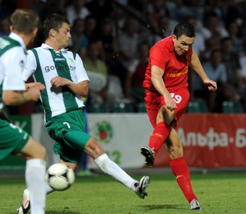 Stewart Downing (R) of Liverpool scores past Sergei Kazeka (2R) of Gomel on August 2, 2012 in Gomel during their third qualifying round match of UEFA Europa League.