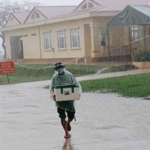 Hình ảnh anh lính đội mưa, khệ nệ bê thùng xốp tiếp tế lương thực cho người dân ở khu cách ly khiến ai nấy đều ấm lòng - Ảnh 2.