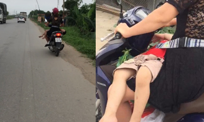 Thót tim cảnh mẹ 'vắt ngang' con trên đùi rồi bình thản lái xe