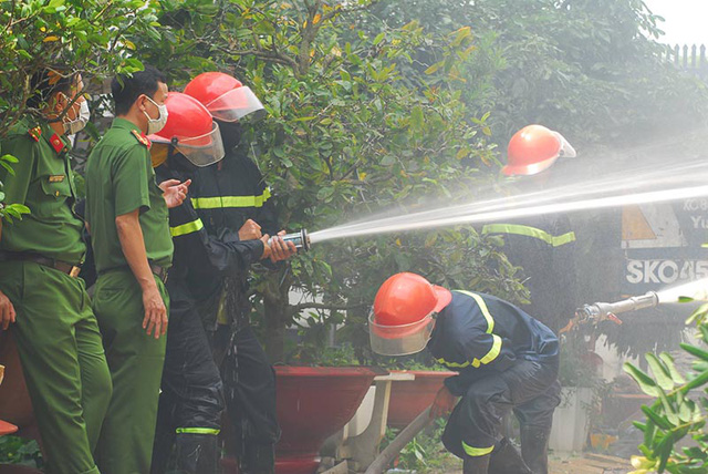 Lực lượng chức năng phun nước dập lửa tại hiện trường