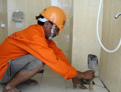 Nhân viên một công ty cung ứng dịch vụ tân trang nhà cửa đang sửa chữa nhà vệ sinh của một khách hàng. Ảnh: TRẦN THẮNG