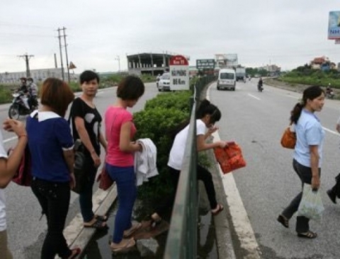 Hàng ngày vào các giờ cao điểm, hàng trăm lượt học sinh, sinh viên, công nhân… chui rào băng qua quốc lộ 5 đoạn qua xã Dương Xá, Gia Lâm, Hà Nội