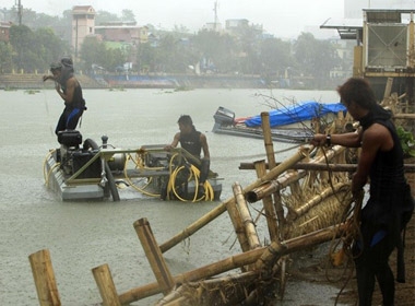 Ngư dân khiêng thuyền tới nơi an toàn hôm 7/11 để tránh bão Haiyan tại Ormoc, Philippines. Ảnh: EPA
