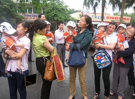 Các bé trai trong vòng tay nhân viên Trung tâm Bảo trợ trẻ em có hoàn cảnh đặc biệt tỉnh Quảng Ninh