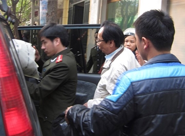 Ông Hồ Văn Hải được áp tải lên xe về trại tạm giam sau khi tiến hành khám xét nhà riêng. 