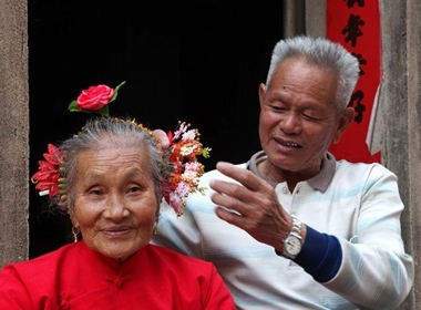 Cụ ông Zheng Xiya (78 tuổi) cài hoa lên đầu vợ ở Tuyền Châu, Phúc Kiến vào ngày 10/3/2013.